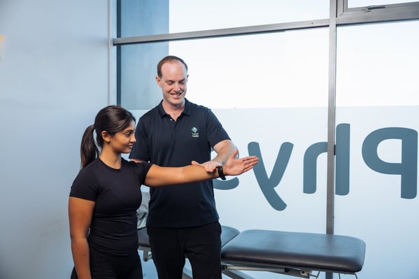 Habit Health physiotherapist Michael Linney conducting an upper limb assessment with a patient at an Auckland clinic